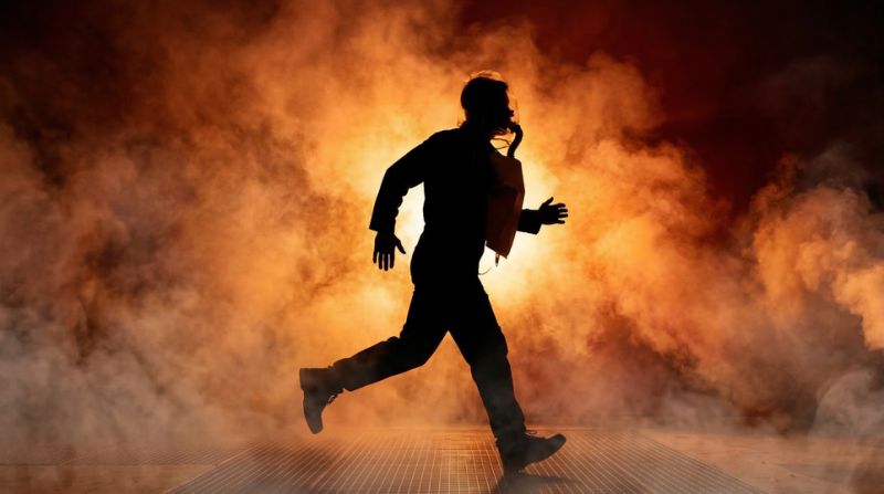 Person wearing an EEBD and escaping a hazardous, smoke filled area